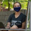 A student working in the Poetry Garden, wearing a mask.