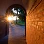 A beautiful sunset glowing through the arched walkway in Morse-Ingersoll hall.